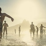 Image of people playing soccer on the beach